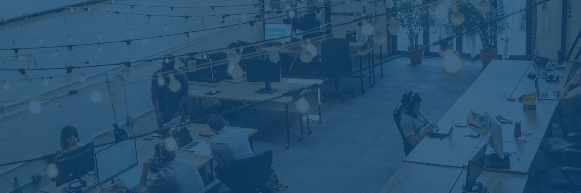 Photo of a freight brokerage office with people working at computers.