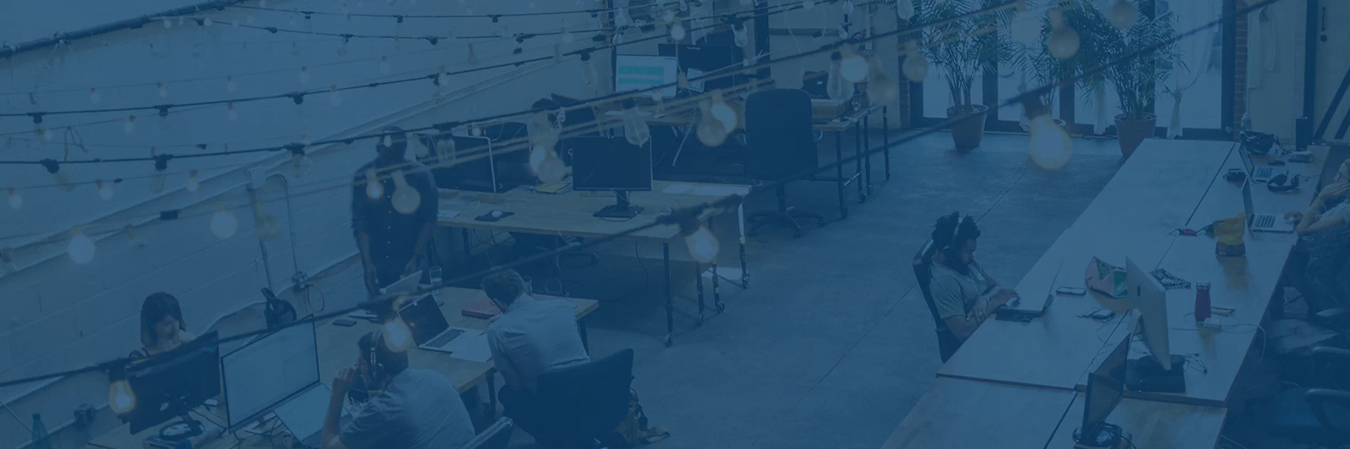Photo of a freight brokerage office with people working at computers.
