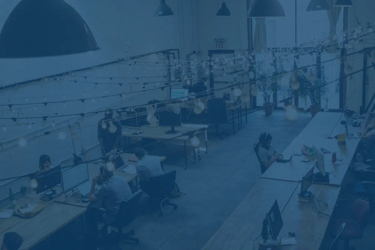 Photo of a freight brokerage office with people working at computers.